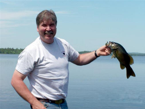 Outfitter Bob Parker with a Plafrey Lake Bass Outfitter Bob Parker with a Plafrey Lake Bass